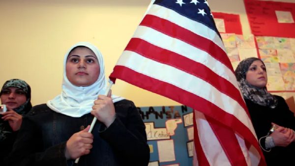 Muslim female student holding American flag